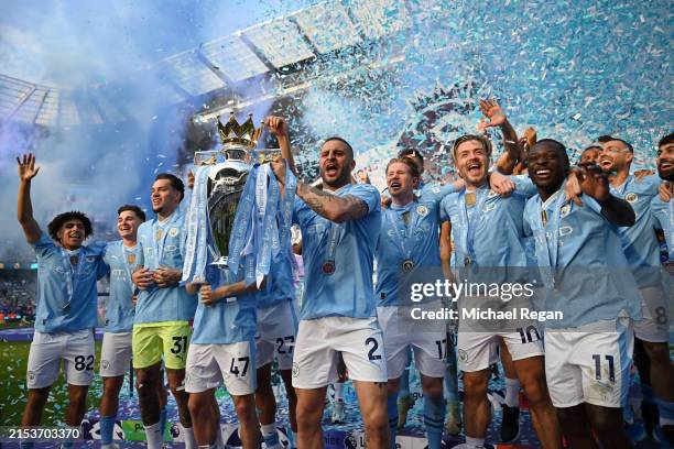 Kyle Walker of Manchester City lifts the Premier League Trophy after their team's victory during the Premier League match between Manchester City and...