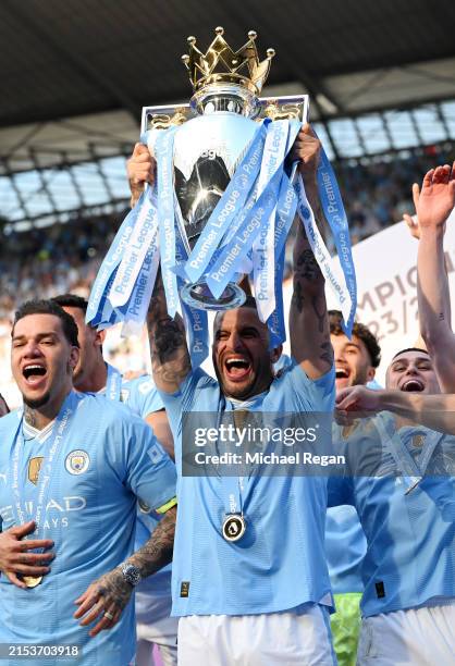 Kyle Walker of Manchester City lifts the Premier League Trophy after their team's victory during the Premier League match between Manchester City and...