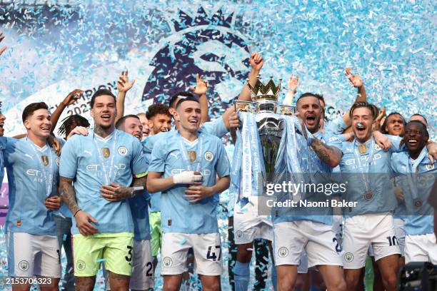 Kyle Walker of Manchester City lifts the Premier League Trophy after their team's victory during the Premier League match between Manchester City and...