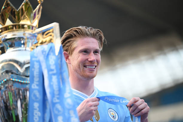Kevin De Bruyne of Manchester City poses for a photo with the Premier League title trophy following the team's victory in the Premier League match...