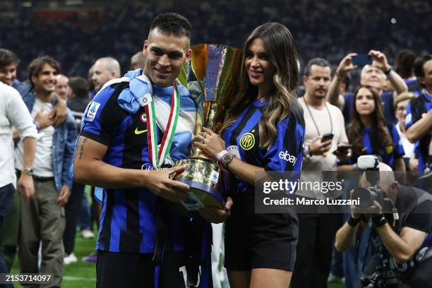 Lautaro Martinez of FC Internazionale poses for a photo with his wife, Agustina Gandolfo, following the Serie A TIM Scudetto title trophy at...