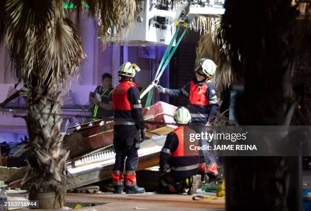 Emergency staff's members work after a two-storey restaurant collapsed, killing four and injuring at least 17 people on Playa de Palma, south of the...