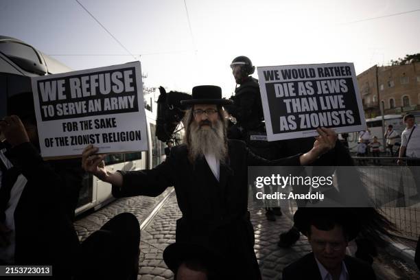 Israeli forces intervene in Ultra-Orthodox Jews who stage a demonstration on tramline to protest the mandatory armed service West Jerusalem on May...