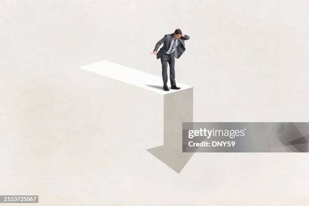man looks down at arrow - failure stock pictures, royalty-free photos & images