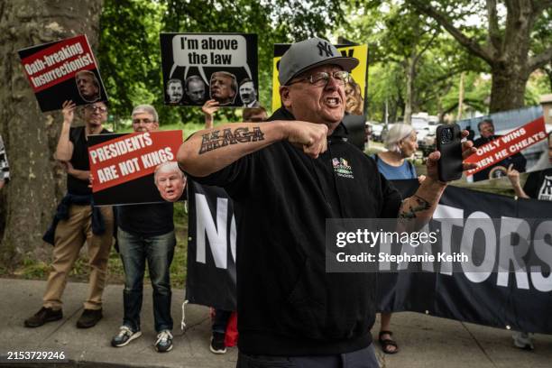 Man with a MAGA tattoo yells in front of where protesters against former U.S. President Donald Trump gather outside of the Crotona Park rally venue...