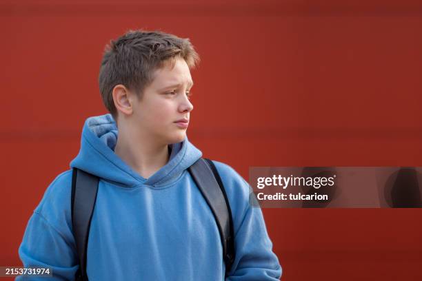 school worries: teen boy contemplating future - hood clothing stock pictures, royalty-free photos & images
