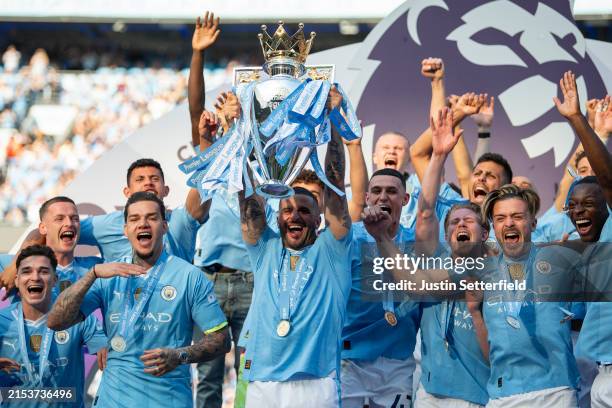 Kyle Walker of Manchester City lifts the Premier League Trophy after their team's victory during the Premier League match between Manchester City and...