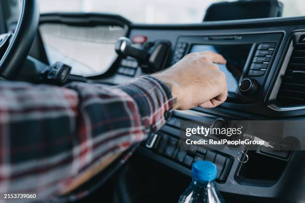 driver adjusting car radio system - global positioning system stock pictures, royalty-free photos & images