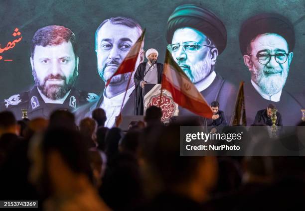An Iranian cleric is delivering a sermon during a religious gathering commemorating the death of the late Iranian President Ebrahim Raisi, who died...