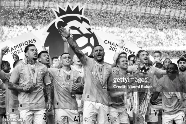 Kyle Walker of Manchester City lifts the Premier League Trophy after their team's victory during the Premier League match between Manchester City and...