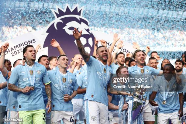 Kyle Walker of Manchester City lifts the Premier League Trophy after their team's victory during the Premier League match between Manchester City and...