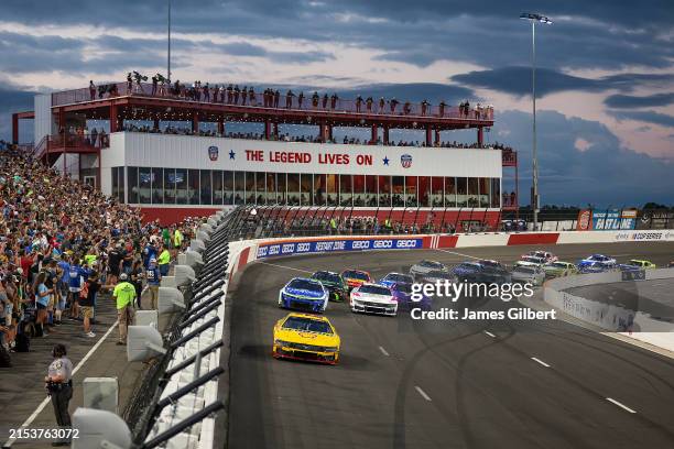 Joey Logano, driver of the Shell Pennzoil Ford, leads the field during the NASCAR Cup Series All-Star Race at North Wilkesboro Speedway on May 19,...