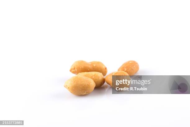 peanut nuts salt in heap isolated on white background - peanuts isolated stock pictures, royalty-free photos & images