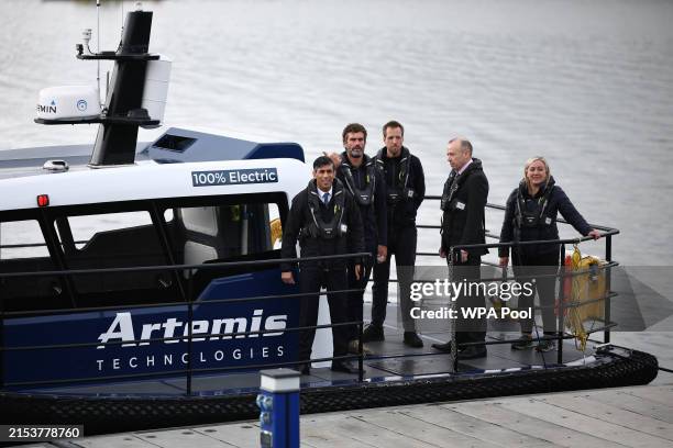 British Prime Minister Rishi Sunak and Britain's Northern Ireland Secretary Chris Heaton-Harris wait on board an Artemis Technologies boat with chief...