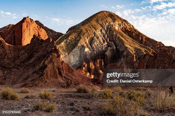 photographer taking a picture of the rainbow valley during sunrise in san pedro de atacama - rainbow valley conservation reserve stock-fotos und bilder