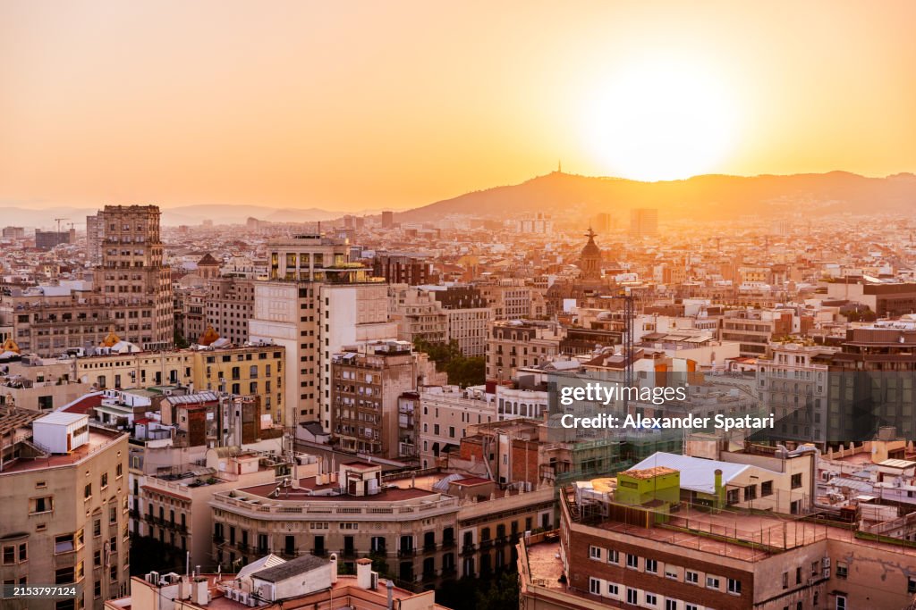 Eixample district and Barcelona skyline at sunset, aerial view, Catalonia, Spain