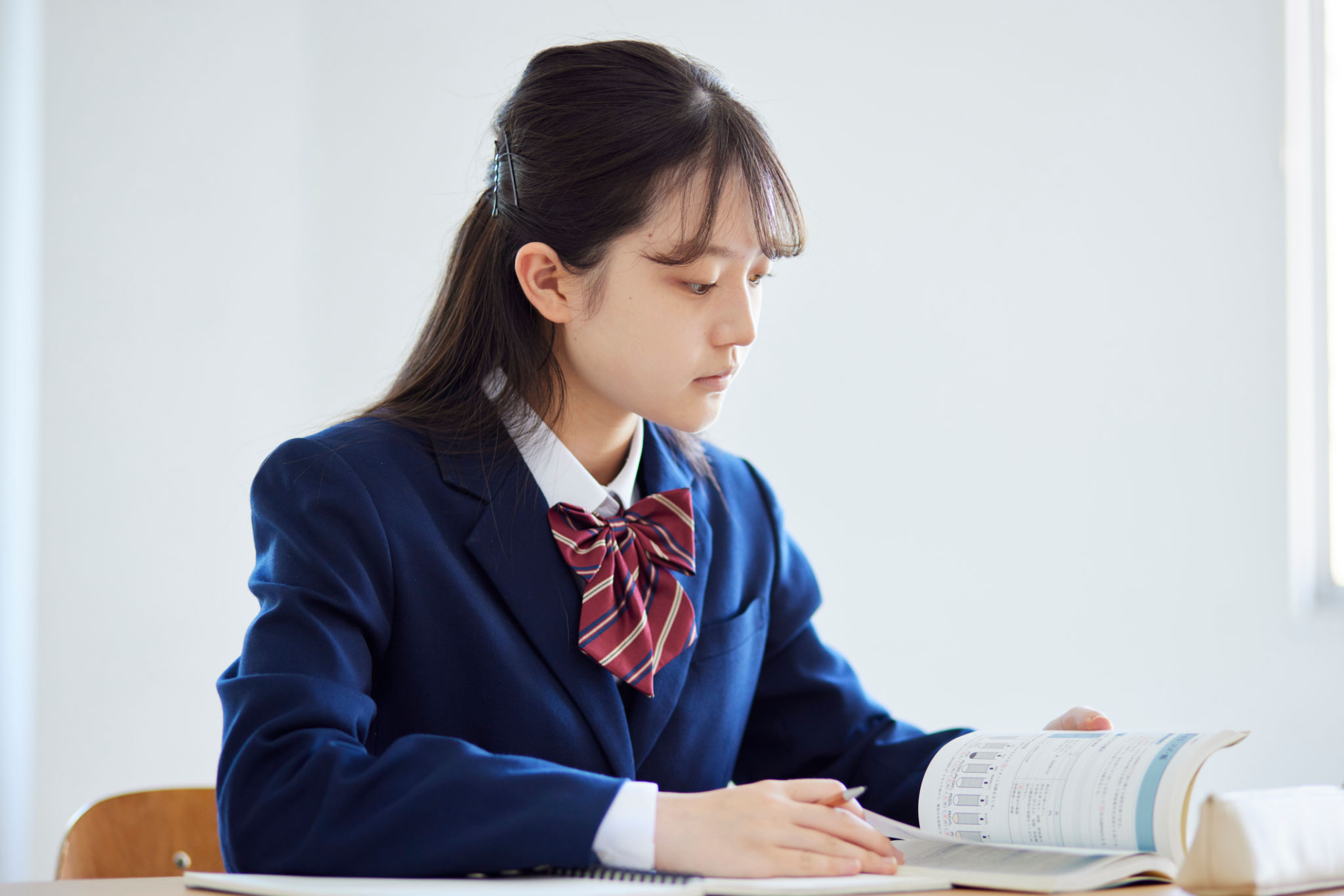 Japanese female high school student taking classes in a high school classroom Japanese female high school student taking classes in a high school classroom
