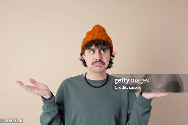 headshot of confused young man - verward stockfoto's en -beelden