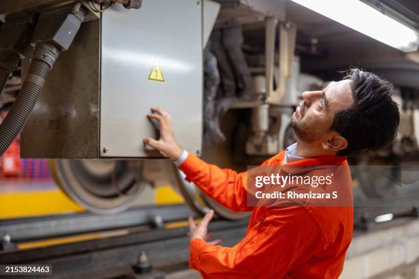 safety incident involving caucasian train engineer experiencing electric shock during train repair underscores the importance of workplace safety compliance and hazard prevention in railway operations - electric chair stock pictures, royalty-free photos & images