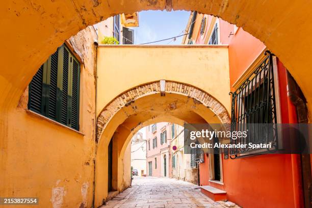 arched alley in corfu old town, corfu island, greece - corfu stock pictures, royalty-free photos & images