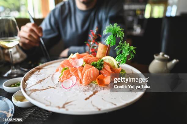 close up of salmon sashimi plate. - foodie stockfoto's en -beelden