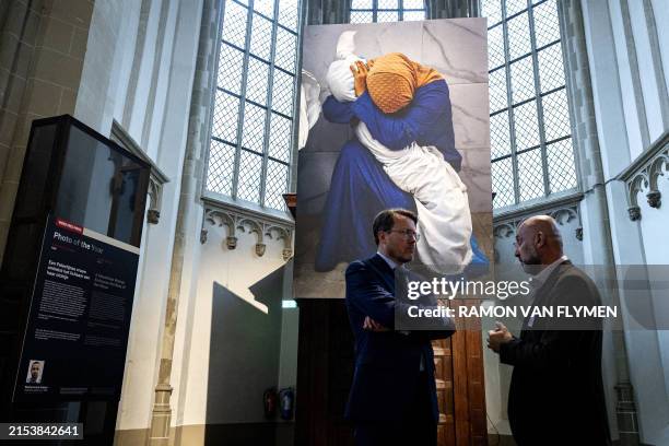 Netherlands' Prince Constantijn speaks with the brother of Reuters' Palestinian photographer Mohammed Salem, winner of the 2024 World Press "Photo of...