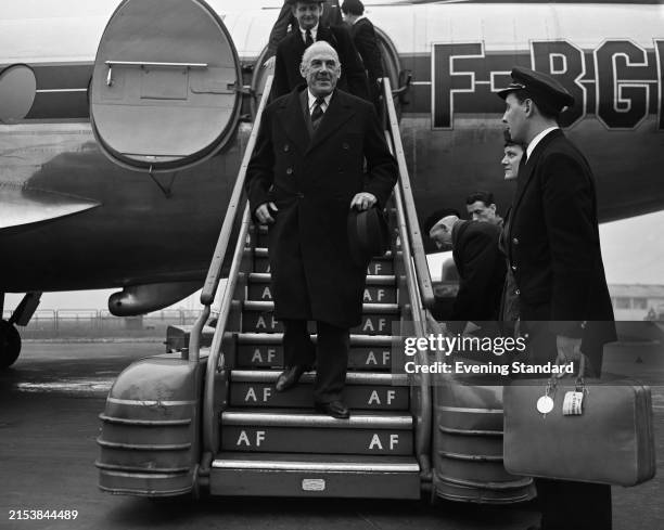 Secretary of State for the Colonies Sir Oliver Lyttelton descends the steps of a plane, March 22nd 1954.