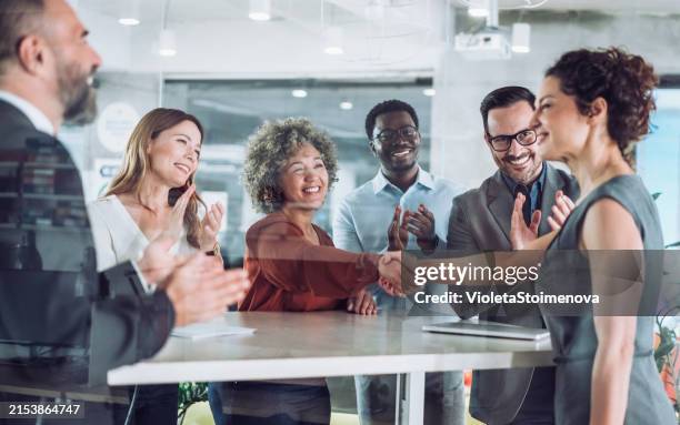 businesspeople shaking hands across the table. - woman-man-handshake-across-table stock pictures, royalty-free photos & images