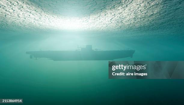 side view of a submarine sailing under the green water in a three-dimensional rendering image - navy submarine stock pictures, royalty-free photos & images