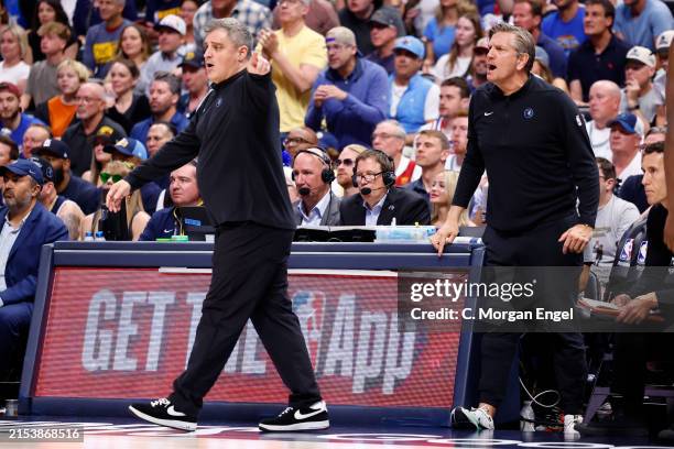 Assistant coach Micah Nori of the Minnesota Timberwolves and head coach Chris Finch of the Minnesota Timberwolves look on against the Denver Nuggets...