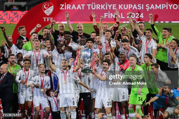Necip Uysal and Cenk Tosun of Besiktas lift the UEFA Turkish Cup trophy after their sides victory during the Turkish cup final match between Besiktas...