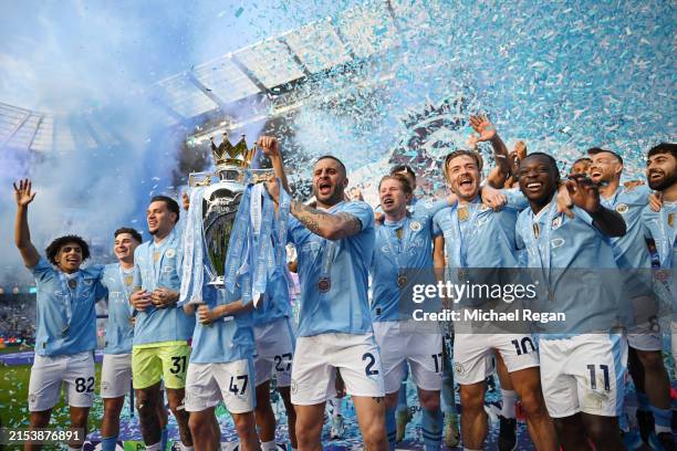 Kyle Walker of Manchester City lifts the Premier League trophy after the Premier League match between Manchester City and West Ham United at Etihad...