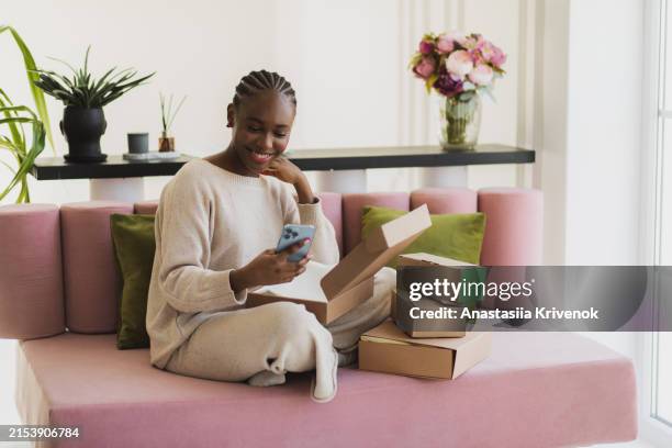 happy woman checking clothes and calling to customer service. - express delivery stock pictures, royalty-free photos & images