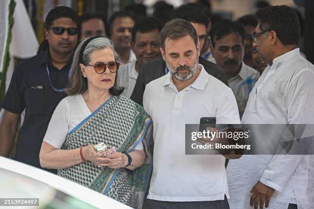 Rahul Gandhi, India's opposition leader, center, with his mother, Sonia Gandhi, former president of the Congress party, at a polling station after...