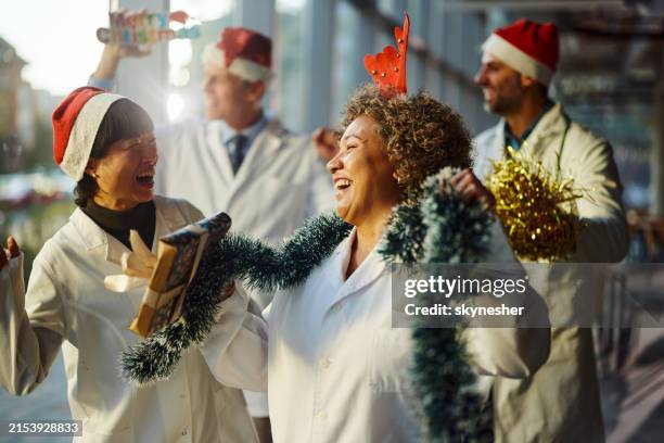 team of happy doctors celebrating christmas in hospital. - medical christmas stock pictures, royalty-free photos & images