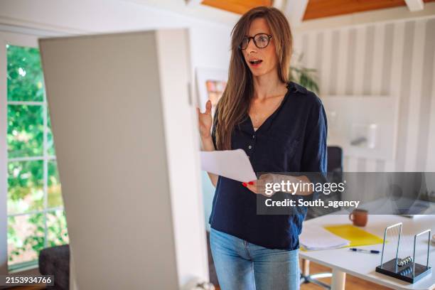 focused woman rehearsing her speech at home - monologue stock pictures, royalty-free photos & images