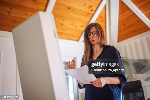 focused woman rehearsing her speech at home - monologue stock pictures, royalty-free photos & images