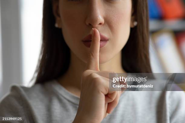 woman asking for silence - people talking hand gestures stock pictures, royalty-free photos & images