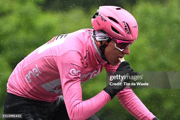 Tadej Pogacar of Slovenia and UAE Team Emirates - Pink Leader Jersey rides whilst eating during the 107th Giro d'Italia 2024, Stage 16 a 118.7km...