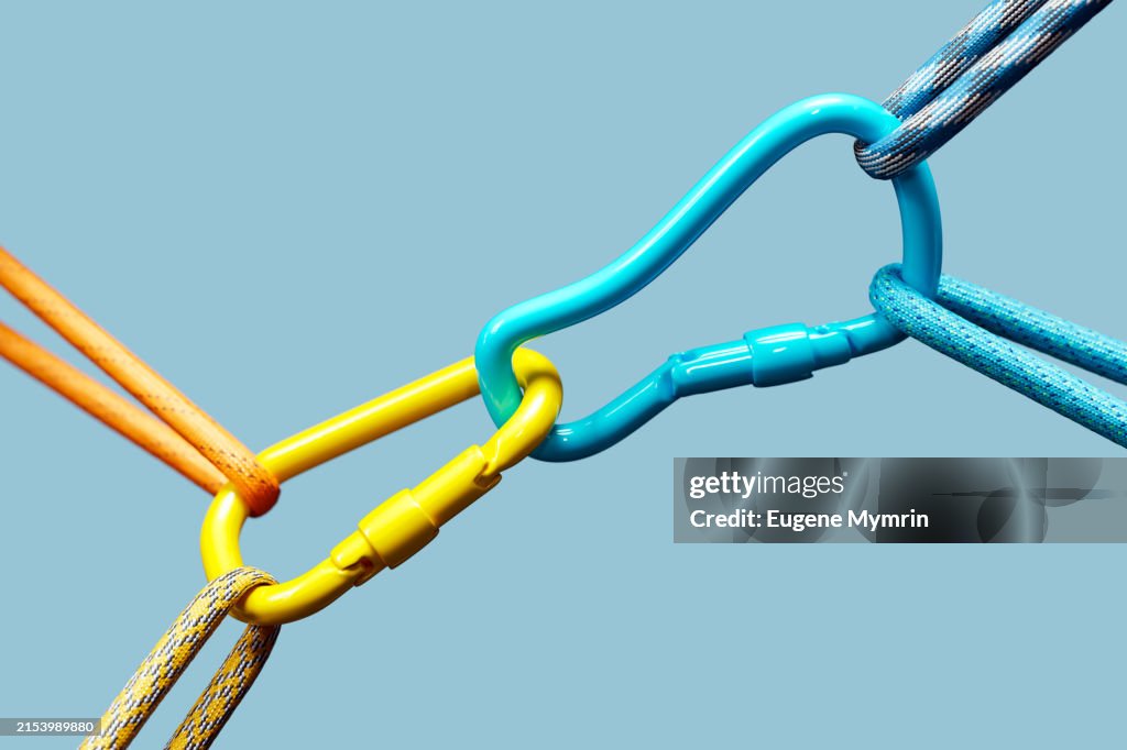 3D Render A Closeup of Two Colorful Carabiners Connected by Ropes on a Blue Background.