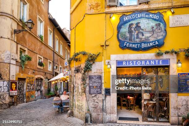a picturesque café and restaurant in the trastevere district in the historic center of rome - sidewalk cafe italy stock pictures, royalty-free photos & images