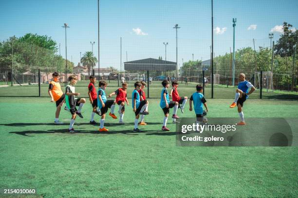 warming up for training on soccer field - kids soccer stock pictures, royalty-free photos & images