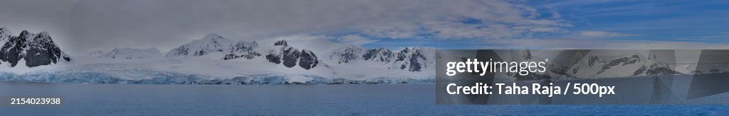 Panoramic view of snowcapped mountains against sky