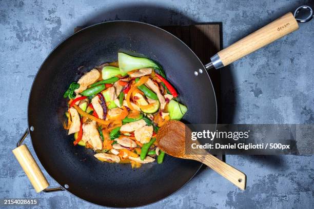 high angle view of food in cooking pan on table - wok stockfoto's en -beelden