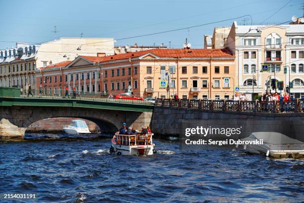 cityscape of fontanka river with tour boat and embankment street with old residential multicolor buildings in the historical center of st. petersburg, russia - embankment stock pictures, royalty-free photos & images