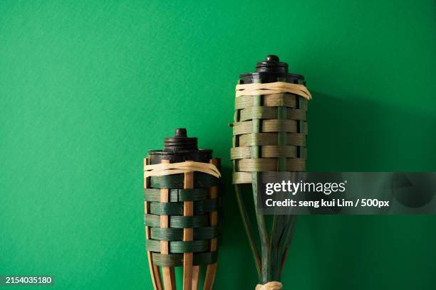 close-up of bottles against green background - oil lamp stock pictures, royalty-free photos & images