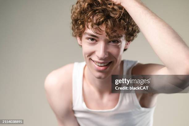 studio portrait of generation z man in white undershirt - undershirt stock pictures, royalty-free photos & images