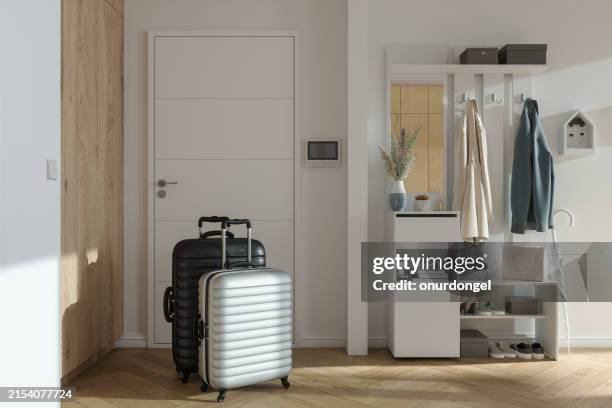 suitcases by the front door. leaving home for travel and holiday - koffer stockfoto's en -beelden