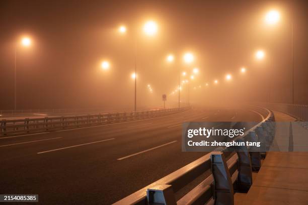 the bridge highway at a fog night. - smog stock pictures, royalty-free photos & images