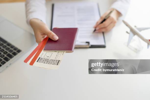 travel agency giving tickets - airplane ticket on table stock pictures, royalty-free photos & images
